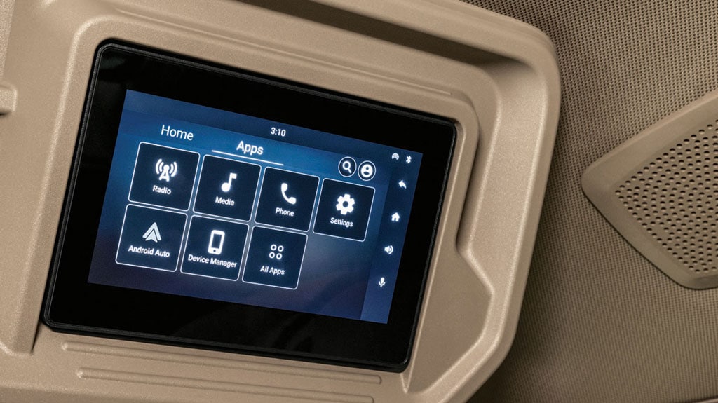 Tractor cab dashboard screen with icons for Radio, Media, Phone, Settings, Android Auto, and more.